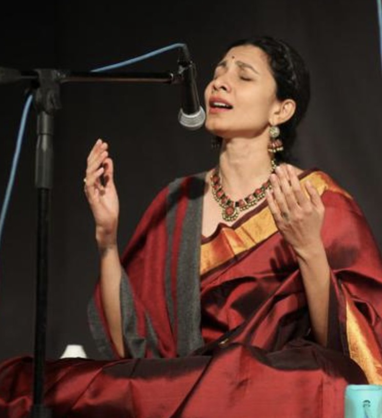Harini Rao, Hindustani classical vocalist, singing in performance in a maroon and gold silk saree